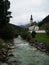 Idyllic rural alpine mountain chapel church St Sebastian at Ramsauer Ache in Ramsau Berchtesgaden Upper Bavaria Germany