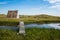 Idyllic rural landscape with small shelter house, with wooden bridge and surrounded by vegetation