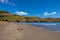 Idyllic sand beach on Akaroa peninsula in New Zealand