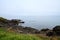 Idyllic scene of a peaceful ocean with rocky shorelines under a clear, blue sky