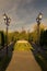 Idyllic scene of street lamps in a tranquil park with a picturesque fountain in the center