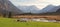 Idyllic scenery with grazing sheeps, bogland and the alps