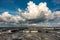 Idyllic seascape with a large white cloud hovering over the tranquil blue ocean waters