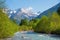 Idyllic spring landscape allgau alps, river Stillach and valley, mountains with snowy peak