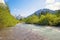 Idyllic spring landscape allgau alps, river Stillach and valley, mountains with snowy peak, south germany