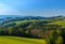 Idyllic spring landscape panorama of a rural hilly countryside in Austria under blue sky