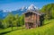 Idyllic springtime landscape in the Alps with traditional mountain lodge