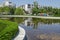 Idyllic springtime landscape with clear pond in the South park near by residential district