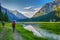 Idyllic summer landscape with hiking people in the mountains with beautiful fresh green mountain pastures, river with reflection