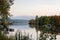 Idyllic sunset over lake in autumn. Sunset boat on lake. Colorful trees reflection in the water. Lake Slnava, Piestany, Slovakia.