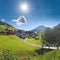 Idyllic swiss tourist resort St Antonien, bright sun and mountain view