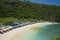 Idyllic tourist destination in Asia - beautiful scenic view of umbrellas in front of turquoise sea water at Atuh beach tropical