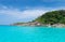 Idyllic tropical blue sea and stone shore