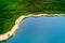 Idyllic turquoise colored lake in the forest aerial