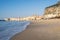 Idyllic view of Cefalu from the long sandy beach. Cathedral and Rocca di Cefalu rocky mountain on a sunny day in Cefalu, Sicily,