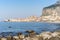 Idyllic view of Cefalu from the long sandy beach. Cathedral and Rocca di Cefalu rocky mountain on a sunny day in Cefalu, Sicily,