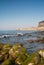 Idyllic view of Cefalu from the long sandy beach. Cathedral and Rocca di Cefalu rocky mountain on a sunny day in Cefalu, Sicily,