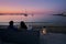 Idyllic view of a couple sitting on a sofa gazing the sunset by the sea in the picturesque seaside village of Naousa in the island