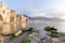 Idyllic view of houses and long sandy beach seen from the old harbour on a sunny day in Cefalu, Sicily, Southern Italy.