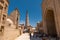 Idyllic view on Islam-Khoja minaret and walking Uzbeks in Khiva old city