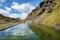 Idyllic view of Seljavallalaug natural geothermal hotspring pool by mountain