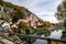 Idyllic view at the village Essing in Bavaria, Germany with the Altmuehl river, high rocks in background and a wooden bridge in