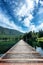 Idyllic view of a wooden pier in the lake with lush forested mountain