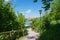 Idyllic walkway at health resort tegernsee with view to the castle, green branches