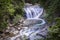 Idyllic waterfall in a forest in Austria