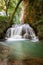 Idyllic Waterfall in rainforest landscape. Water flowing in tranquil scenery.