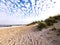 Idyllic white beach with blue skies and dunes