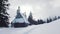 Idyllic winter landscape with snow covered wooden mountain hut