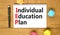 IEP individual education plan symbol. Concept words IEP individual education plan on white note on a beautiful wooden background.