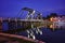 iew of the Greifswald sailing harbor with the historic drawbridge and reflecting lights at the blue hour