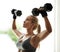 If it doesnt burn, youre not doing it right. a beautiful young woman in workout gear lifting dumbbells.