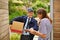 If you could just sign for me there...a male courier delivering a package to a woman at her home.