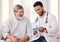 If you follow this routine, youll definitely feel better. a doctor holding a pill box while talking to a senior patient.