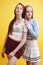 ifestyle people concept: two pretty young school teenage girls having fun happy smiling on yellow background