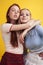 ifestyle people concept: two pretty young school teenage girls having fun happy smiling on yellow background