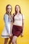 ifestyle people concept: two pretty young school teenage girls having fun happy smiling on yellow background