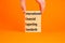 IFRS symbol. Concept words IFRS international financial reporting standards on block on beautiful orange background. Business IFRS