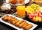 Iftar buffet. Spring roll, fruits, fresh orange juice, samosa snack, spring roll and pancake background concept iftar holy month