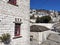 Igiades village on the mountain mitsikeli, greek fllag waving old traditional houses in ioannina