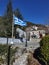 Igiades village on the mountain mitsikeli, greek fllag waving old traditional houses in ioannina