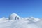 Igloo icehouse under clear blue sky