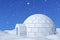 Igloo snowhouse under blue sky with snowfall closeup