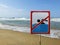 Ign at the beach with man swim and not symbol, Caution No Swimming allowed