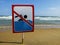 Ign at the beach with man swim and not symbol, Caution No Swimming allowed