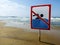 Ign at the beach with man swim and not symbol, Caution No Swimming allowed