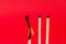 Igniting Spark: Burning Matchstick on Red Background